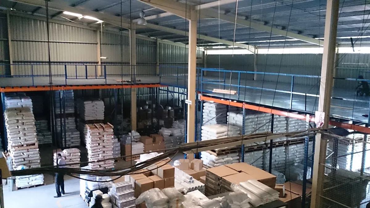 Frame supported mezzanine floor to store raw material for a packaging company in Horana
